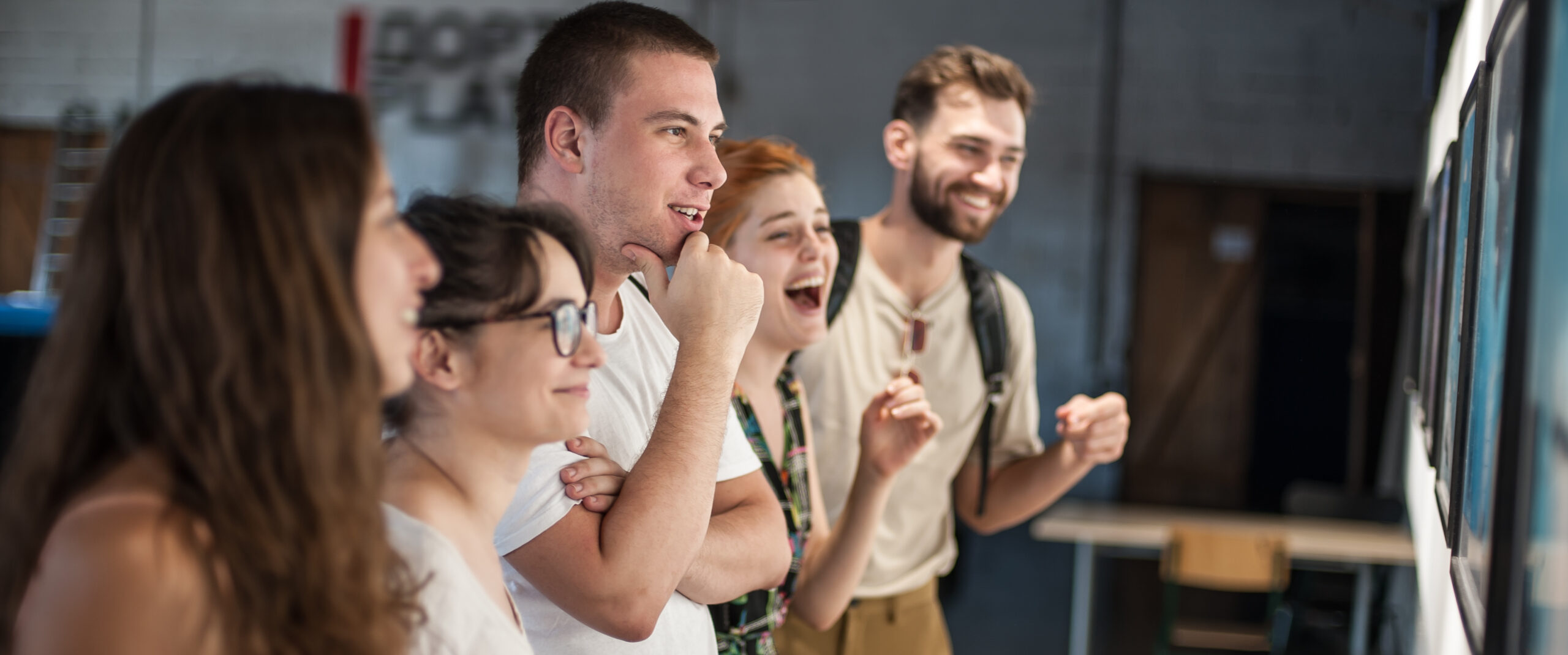 Group of friends in modern art exhibition gallery hall contemplating artwork. Abstract painting